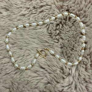 Faux pearl necklace with T bar detail in gold tone
